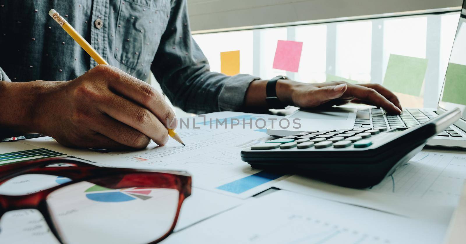 close up businessman pointing at graph and chart to analysis use for plans to improve quality, business finances and accounting concept by nateemee