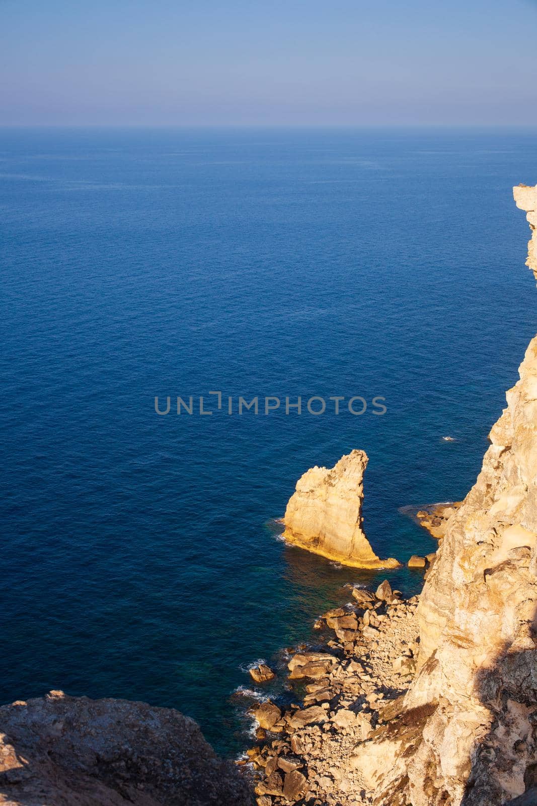 View of the famous cliff called La vela in Lampedusa, Sicily