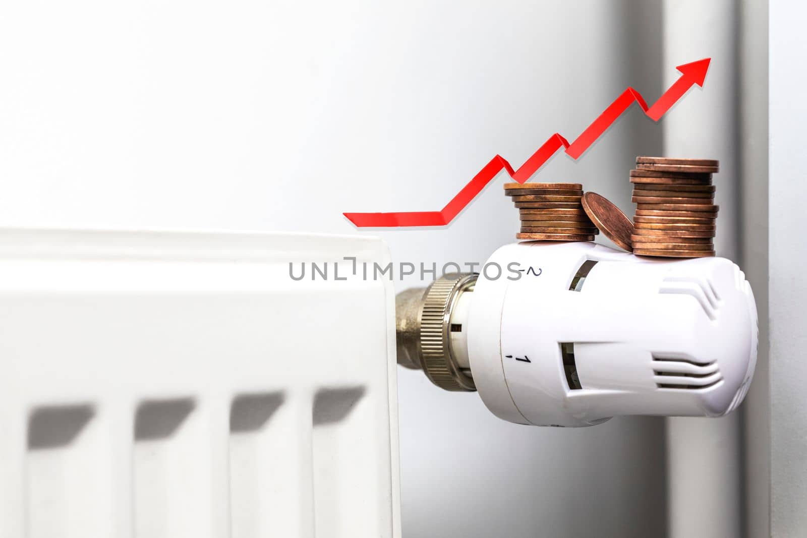 Increasing energy bills. Rising red arrow and coins on a heating radiator. Cost of living crisis. recession inflation concept copy space by Annebel146