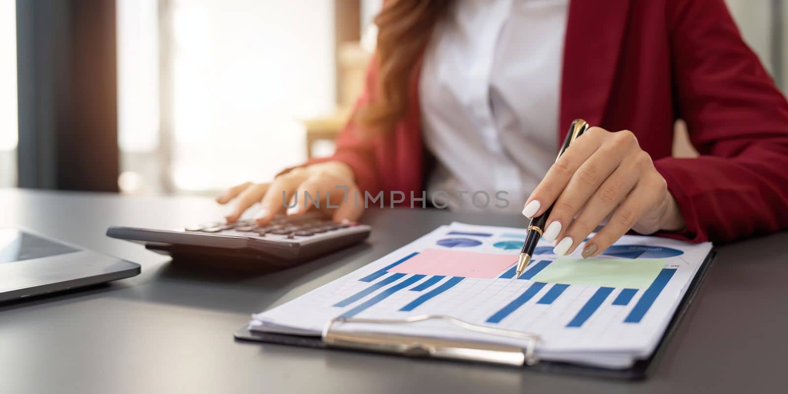 Accountant woman working with calculator and laptop computer, Tax deduction planning concept. Business woman calculating business balance prepare tax reduction by nateemee