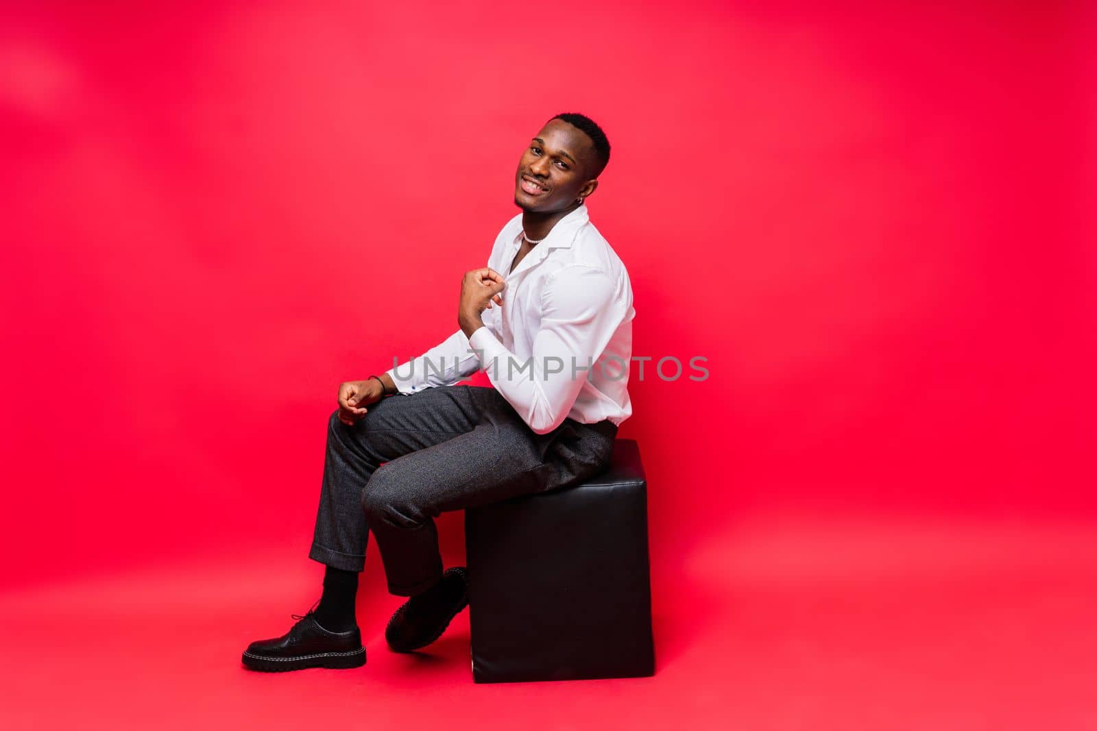 African American millennial businessman isolated on studio background, successful male formal suit by Zelenin