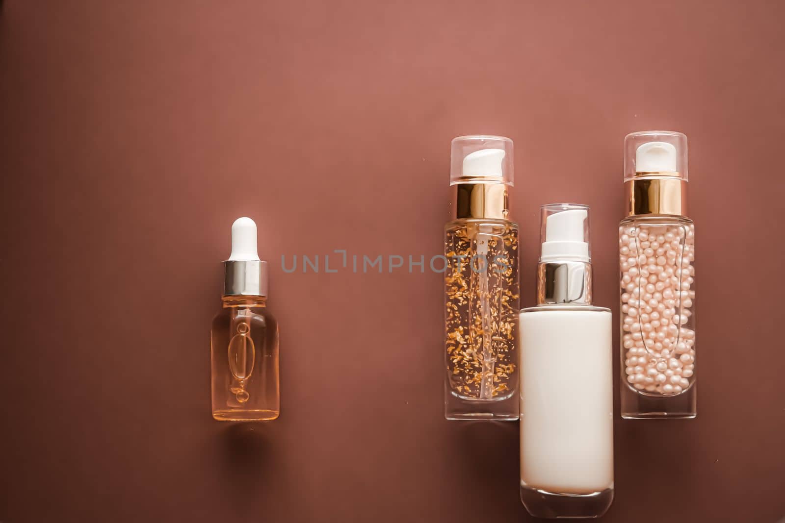 Skincare cosmetics and anti-aging beauty products, luxury skin care bottles, oil, serum and face cream on brown background by Anneleven