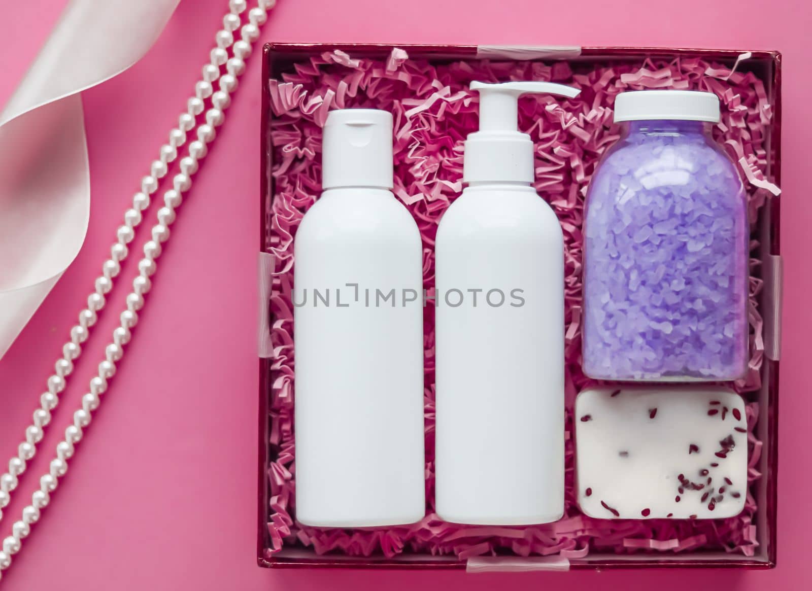 Beauty box subscription package, luxury skincare and body care products, milk lotion, bath salt, soap, shower gel as flat lay on pink background, spa cosmetics as holiday gift, online shopping delivery, flatlay.