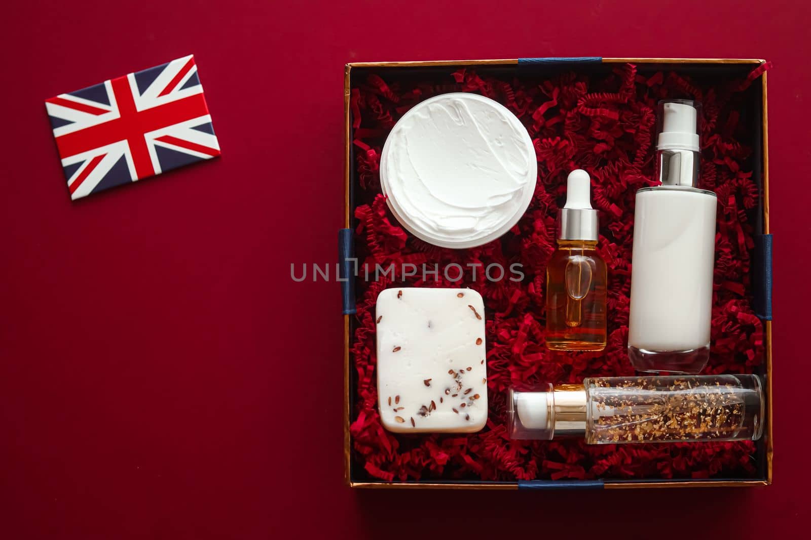 Beauty box subscription delivery in United Kingdom, luxury skincare products, spa and body care cosmetics and UK flag on red flat lay background, online shopping, flatlay view.