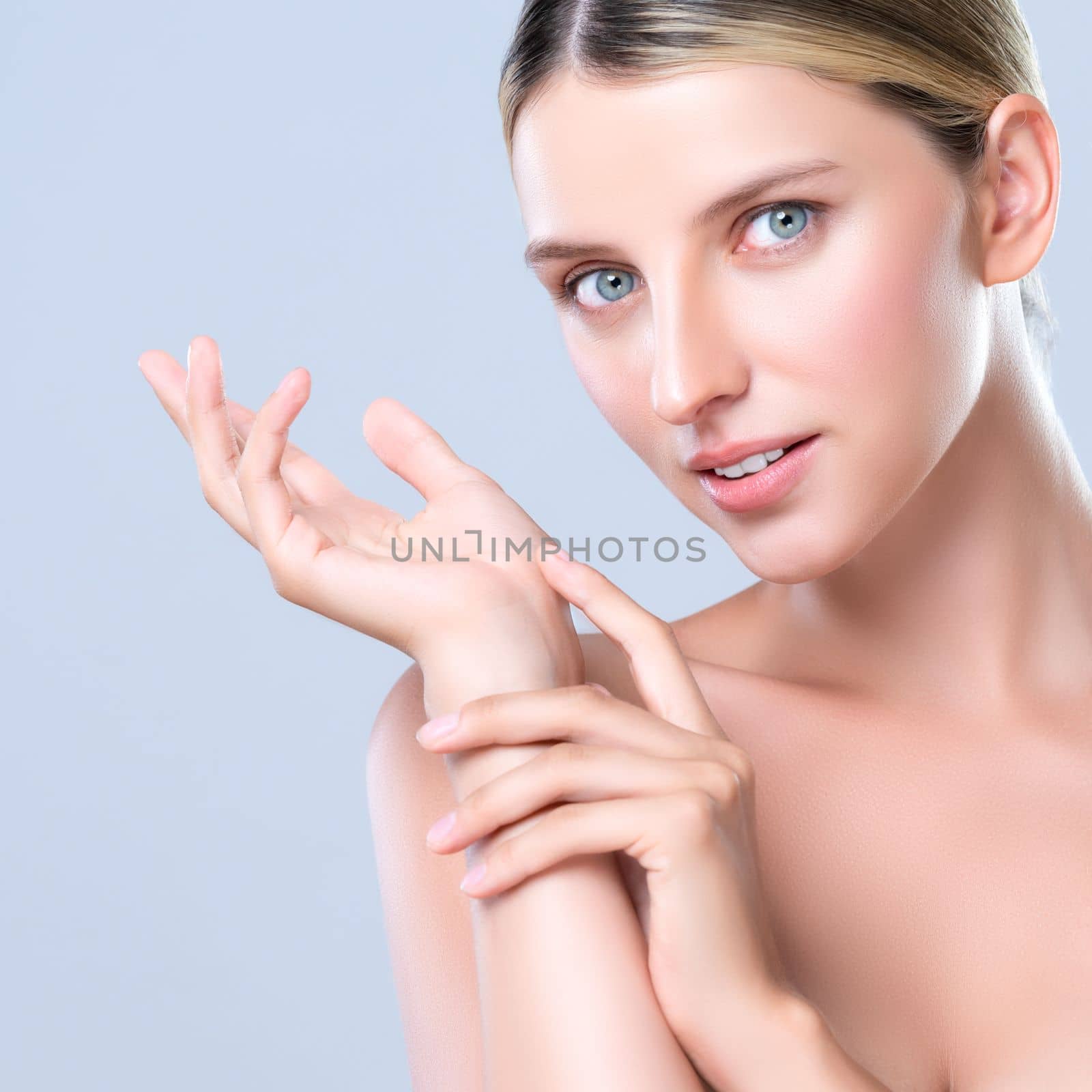 Closeup alluring beautiful woman with perfect smooth and clean skin portrait in isolated background. Beauty hand gesture with expressive facial expression for skincare treatment product or spa.