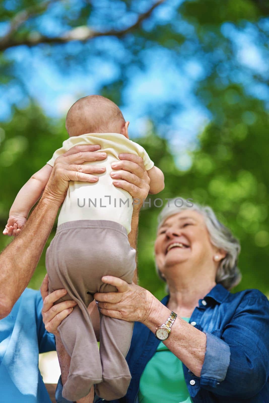 I love my grandson with all my heart. a senior couple spending time with their grandson. by YuriArcurs