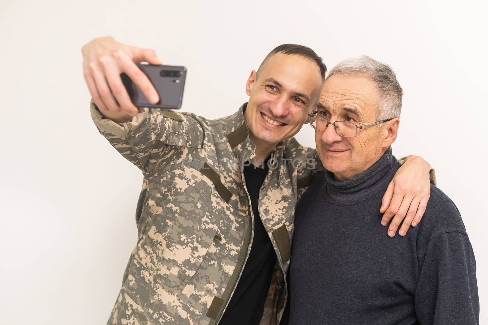 Portrait of army man with parents, elderly father and military son