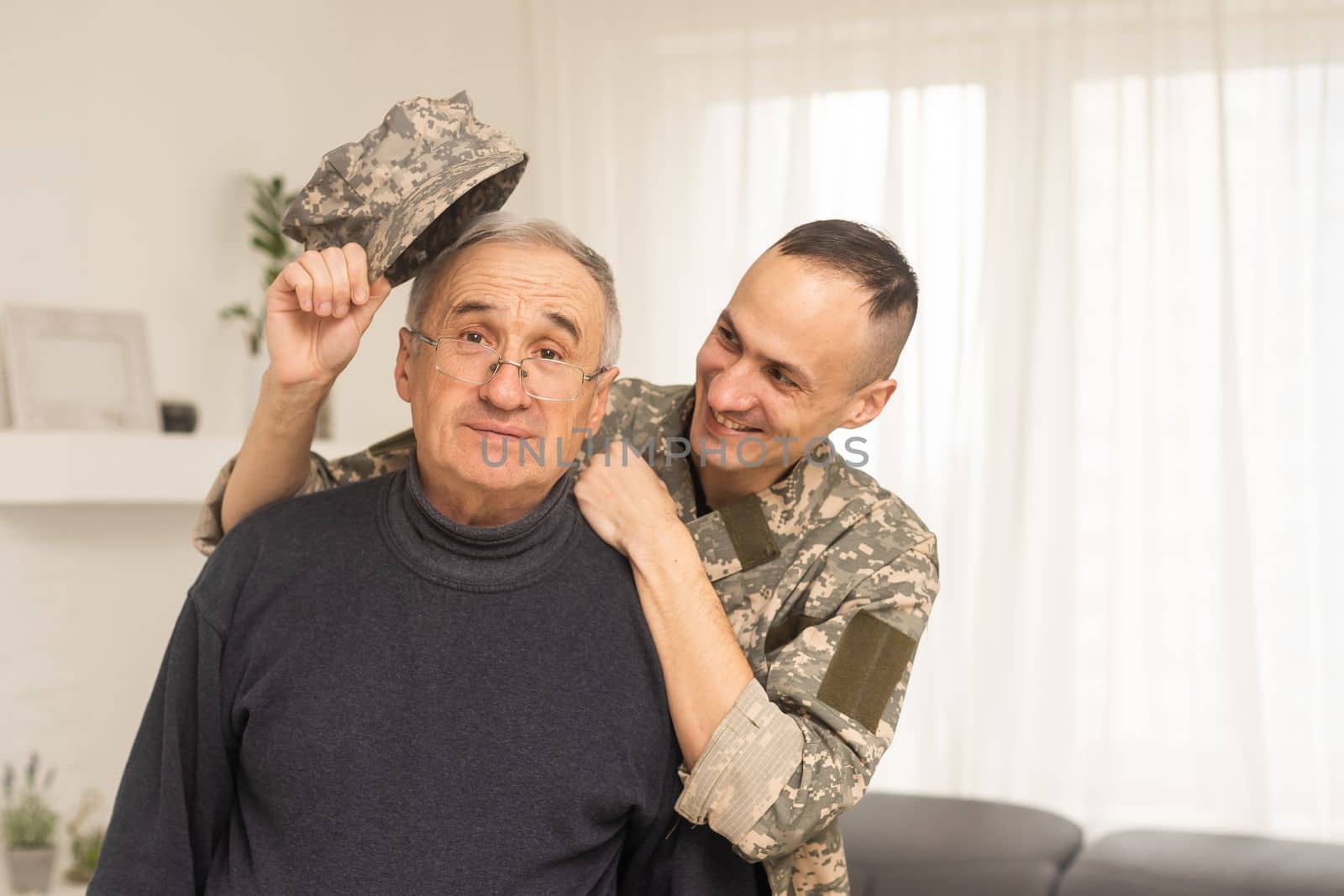 Portrait of army man with parents, elderly father and military son