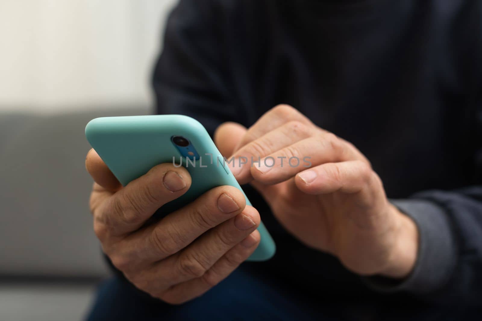 Elderly man using smartphone, mobile phone in male hands close up. Concept of online communication in retirement, sms, social media