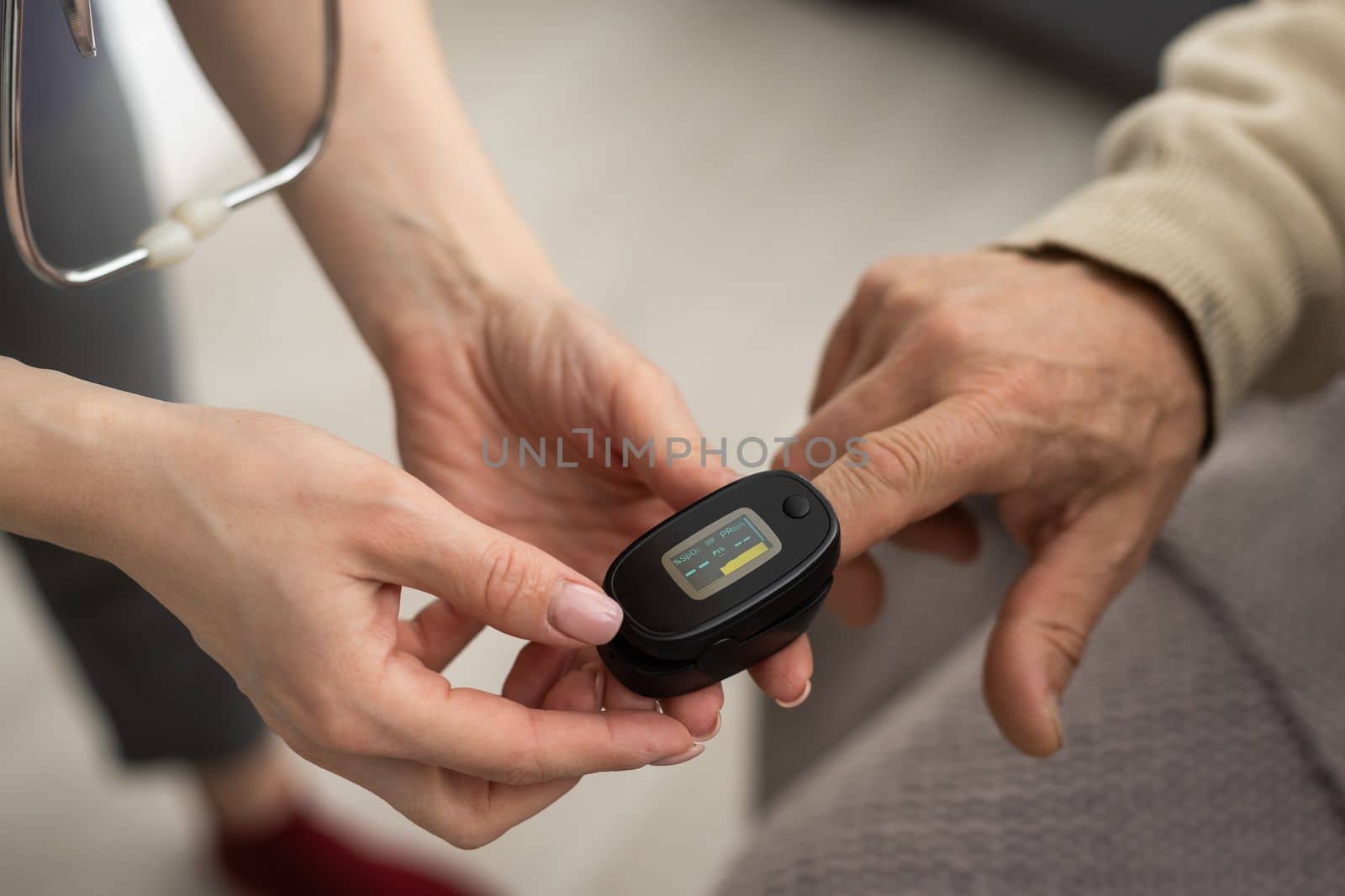 Measurement of oxygen level and pulse rate with a portable pulse oximeter - a man monitors his health by Andelov13