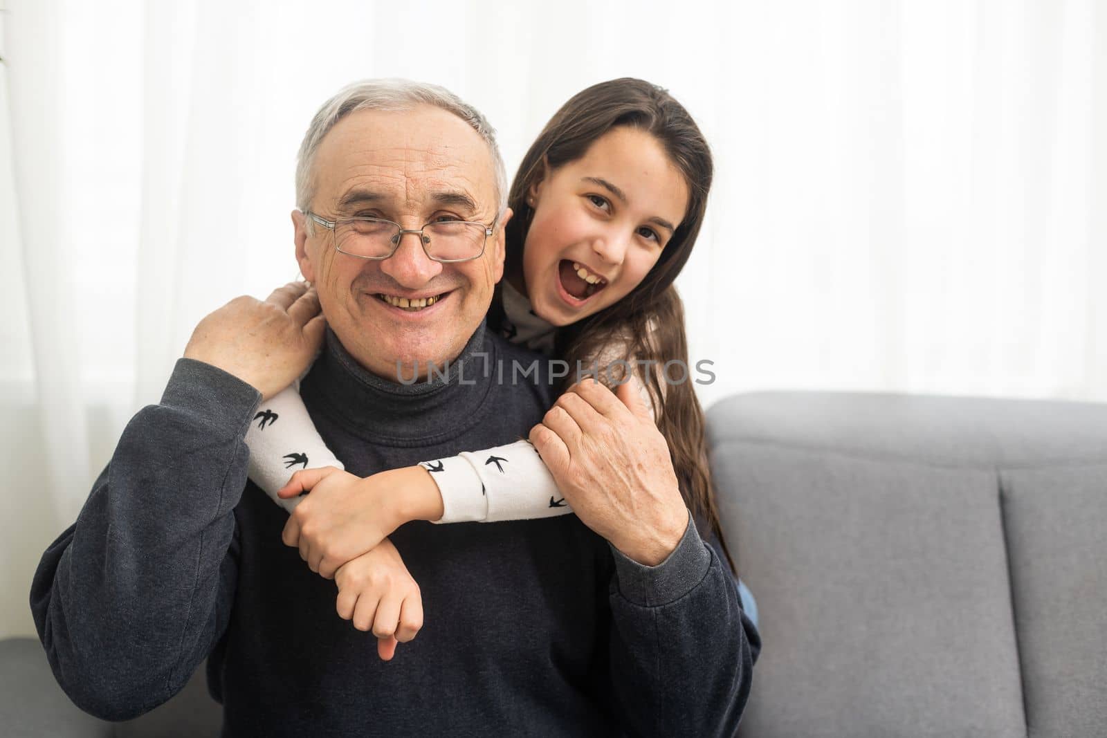 Elderly eighty plus year old man with granddaughter in a home setting
