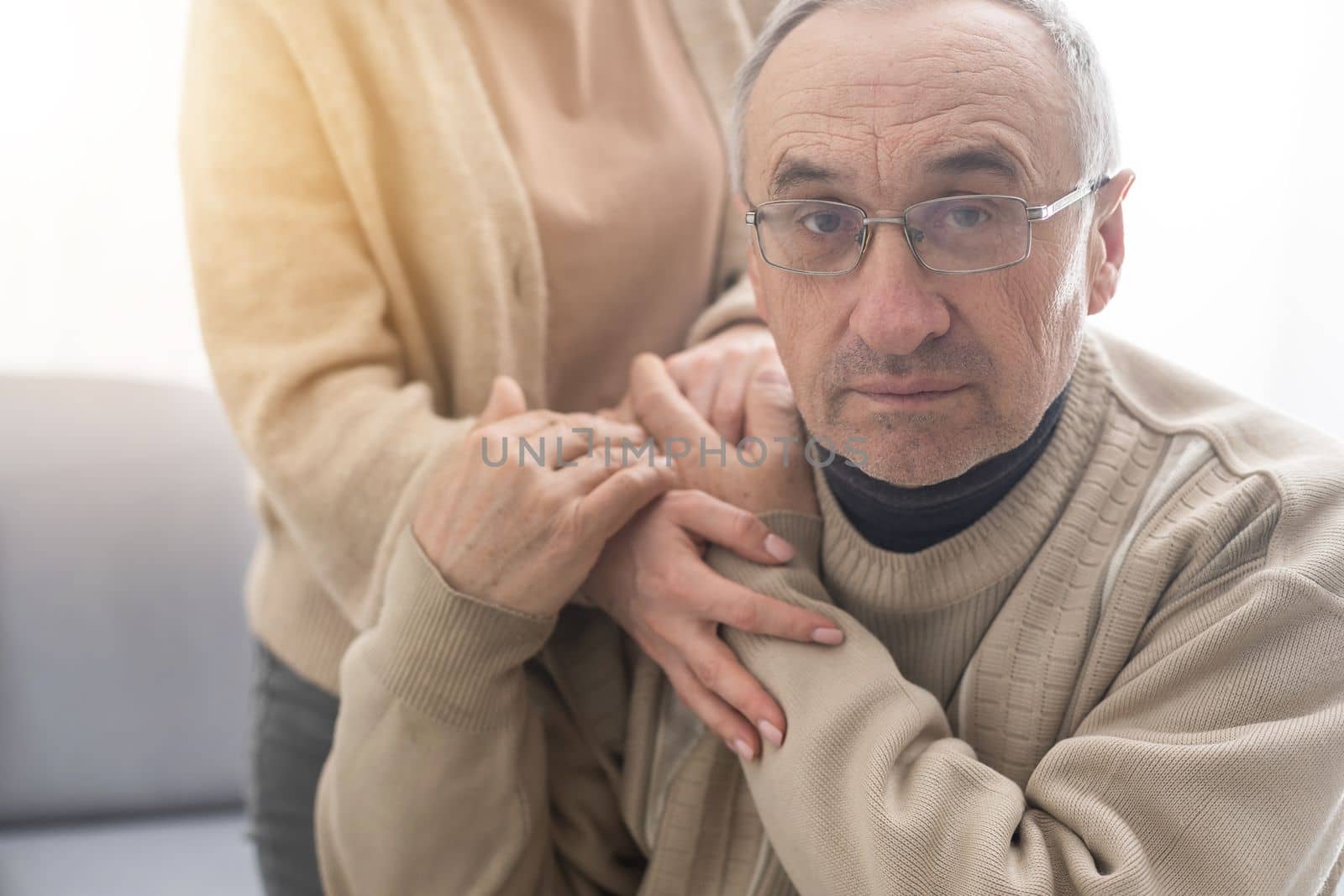 Young woman holding senior man hands, closeup.