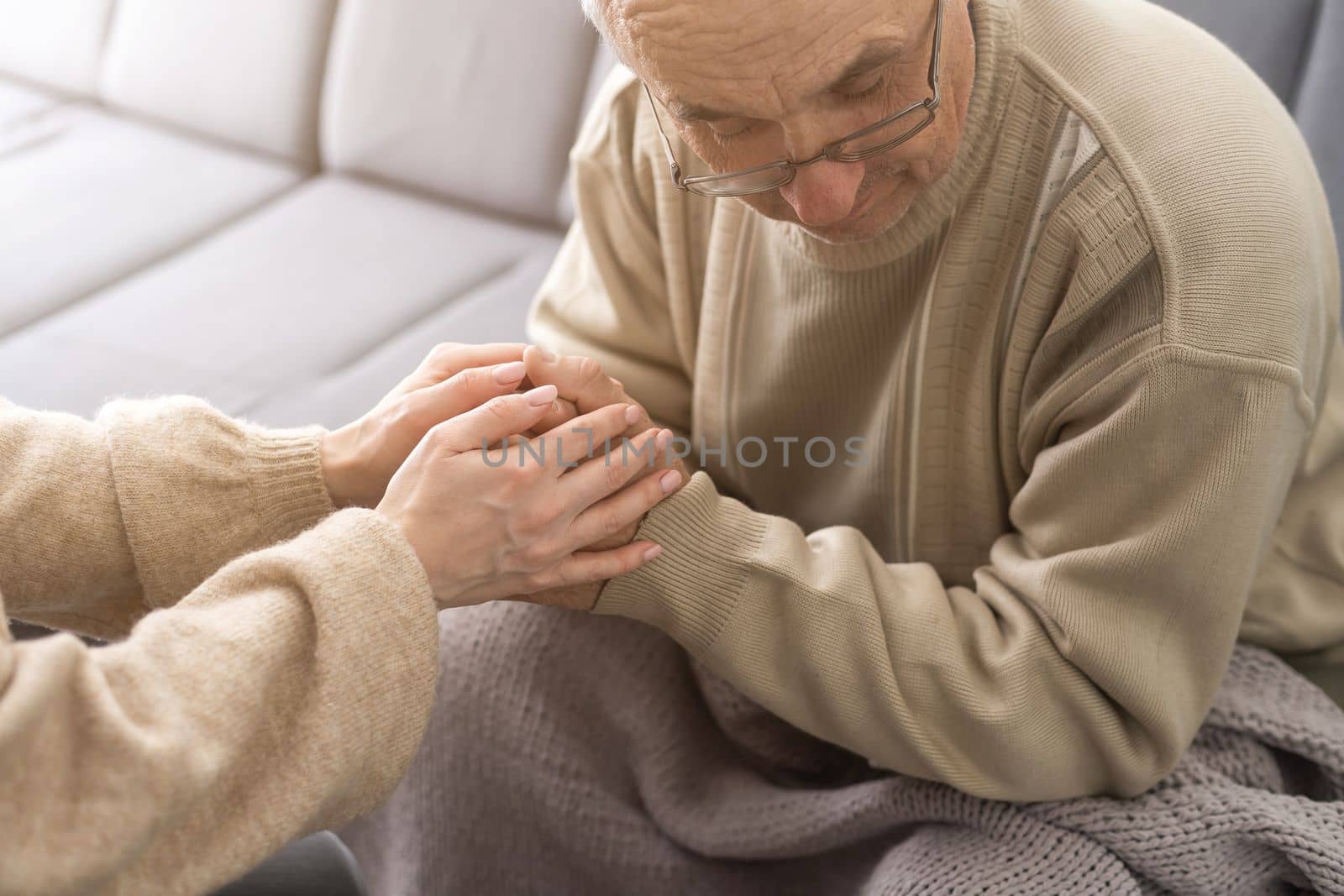 Two people holding hand together. elderly man and support woman by Andelov13