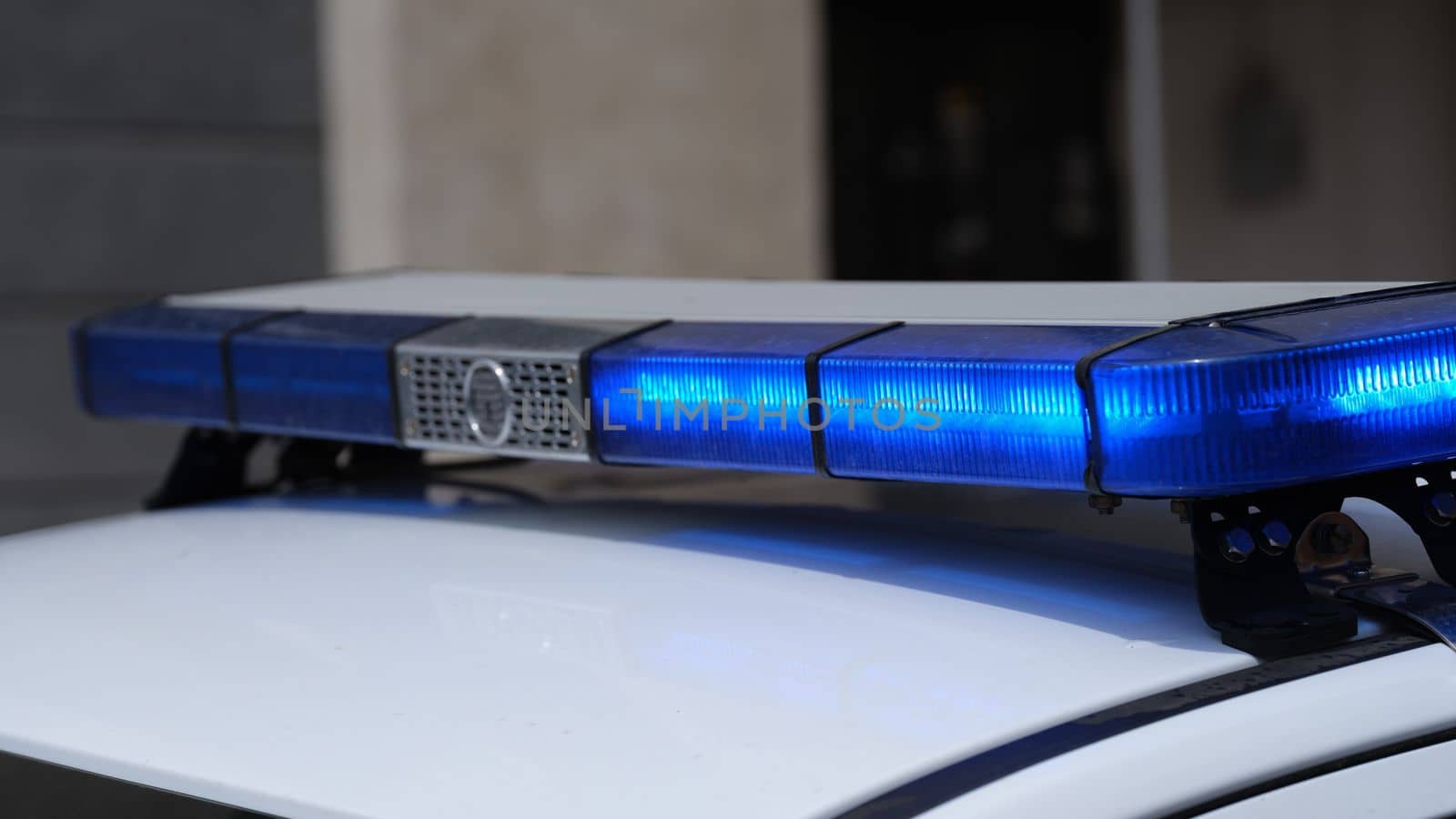 Blue lights on roof of police car in city by kuprevich