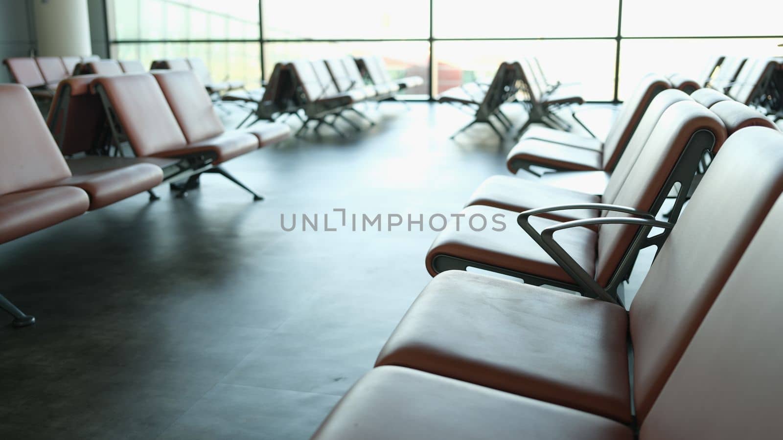 Empty terminal at airport waiting area at gate and air business. Brown leather chair at airport