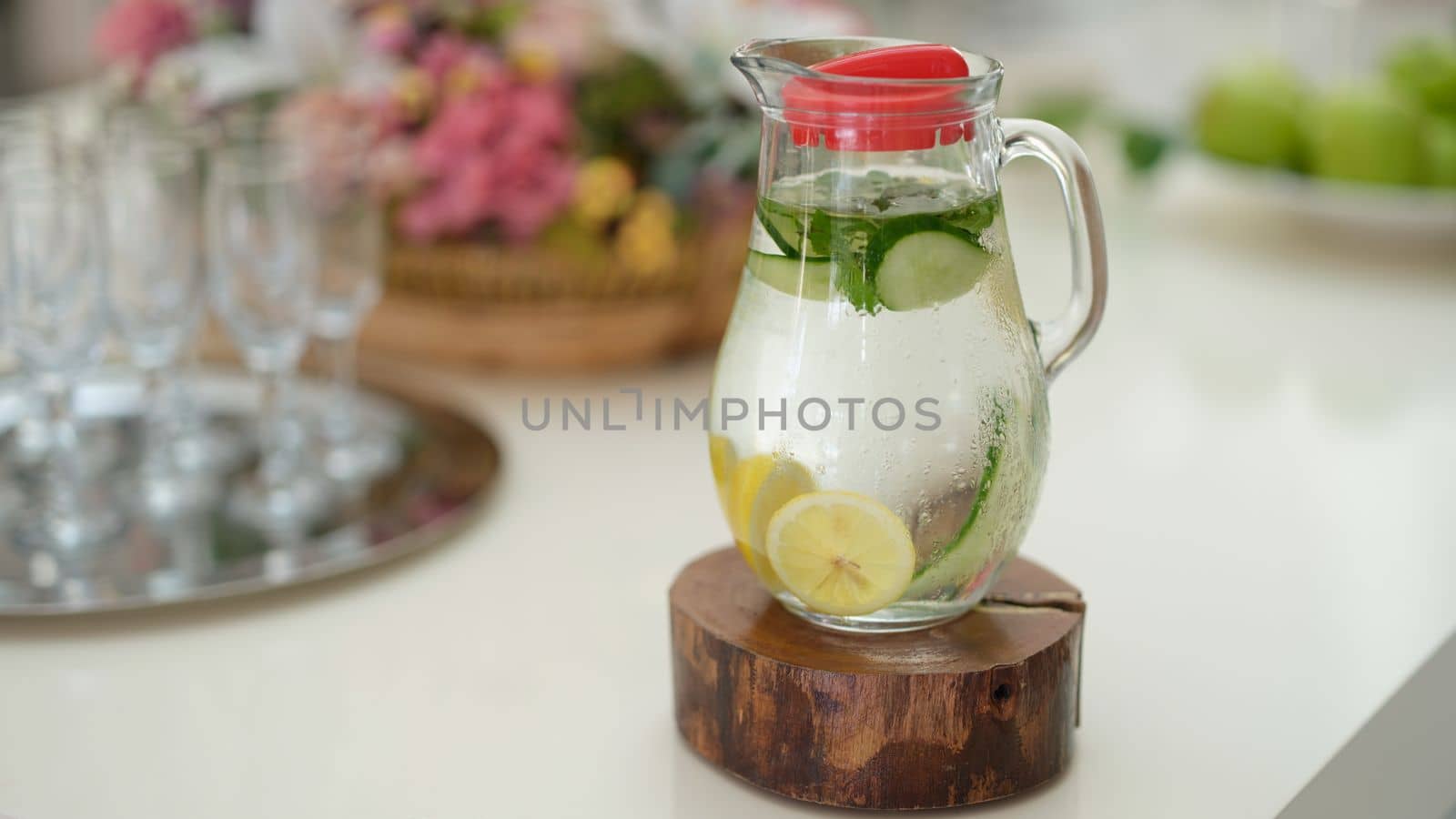 Fruit water with lemon lime cucumber and mint in glass jug by kuprevich