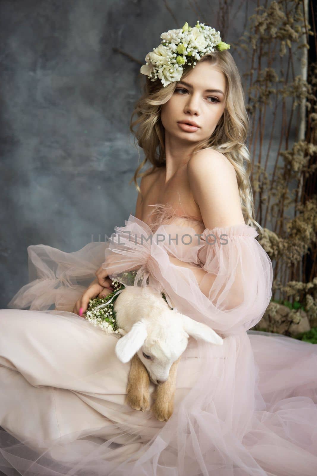A young blonde woman in an airy pink dress with a white kid. Spring portrait of a woman. by Annu1tochka