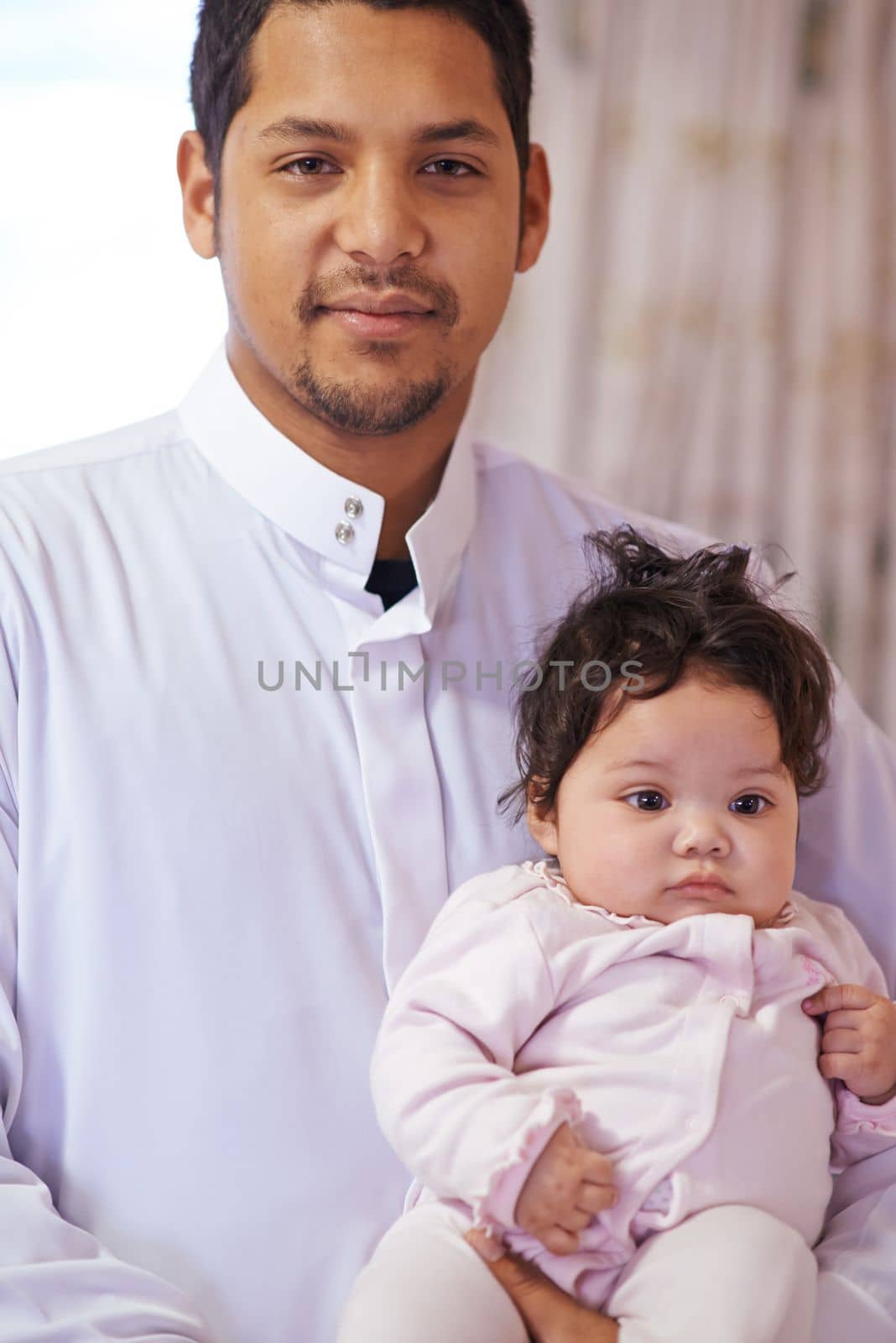 She gets bigger every day. a father cradling his little baby girl