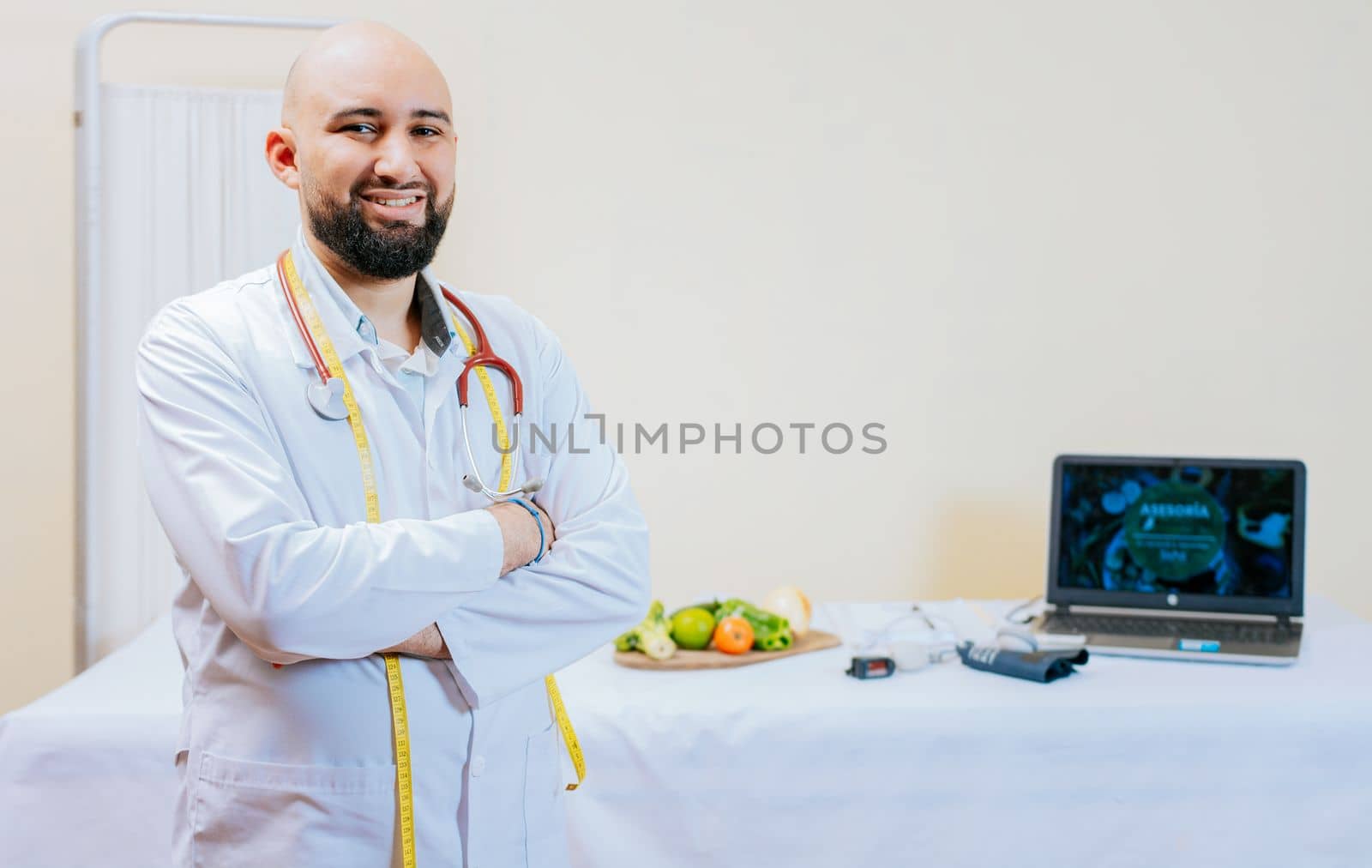 Portrait of smiling male nutritionist at his workplace. Smiling nutritionist doctor with crossed arms in her office. Portrait of smiling professional nutritionist. by isaiphoto
