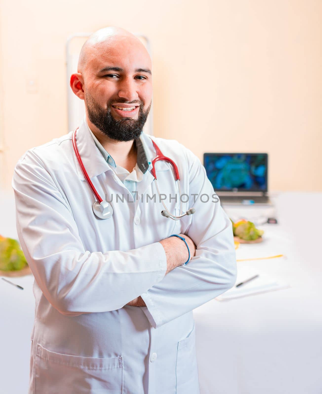 Smiling nutritionist doctor with crossed arms in her office. Portrait of smiling professional nutritionist, Portrait of smiling male nutritionist at his workplace by isaiphoto
