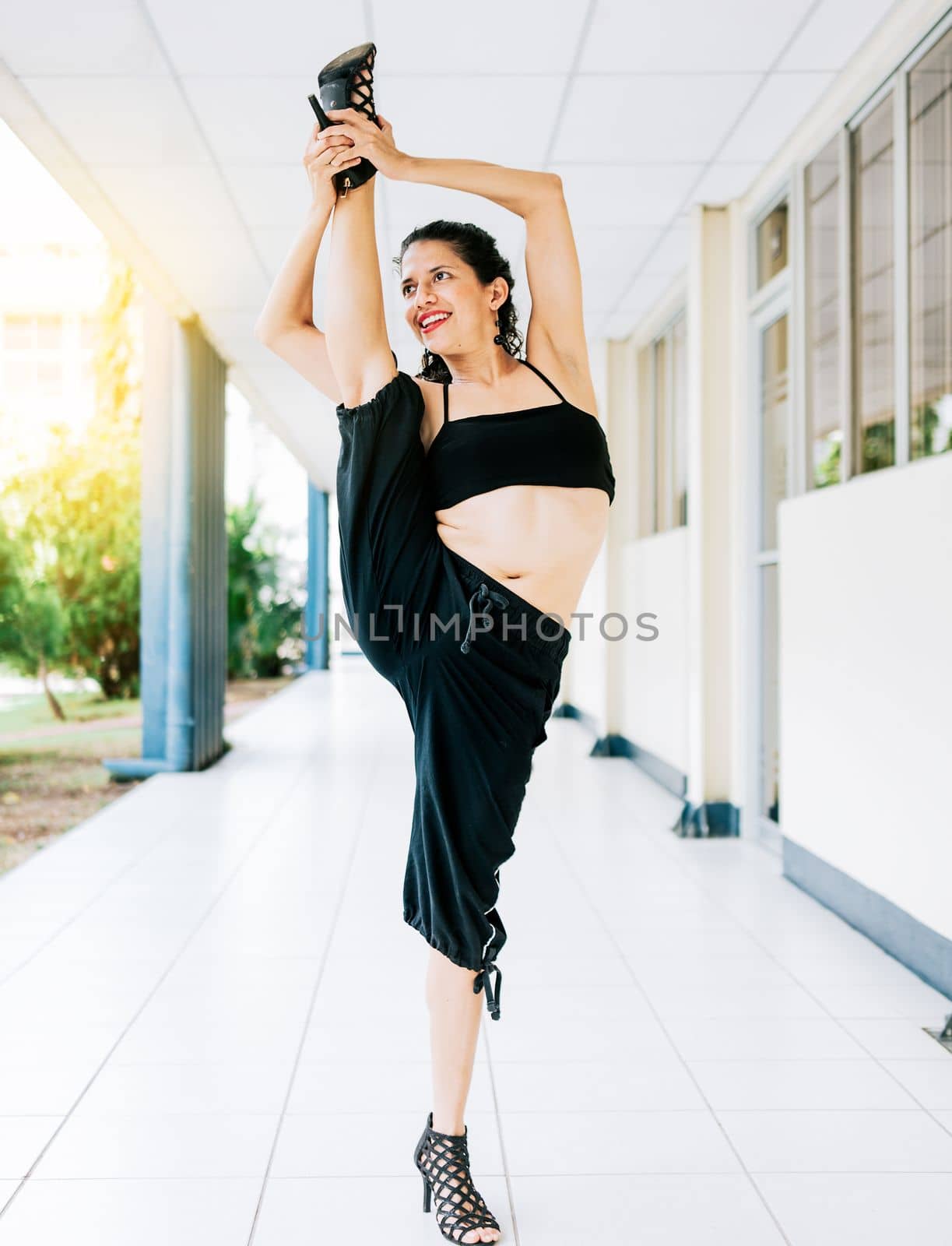 Woman dancer in heels doing yoga flexibilities. Dance artist woman doing acrobatics and flexibilities in heels. Artistic gymnastics concept, Dance girl doing flexibility in high heels by isaiphoto