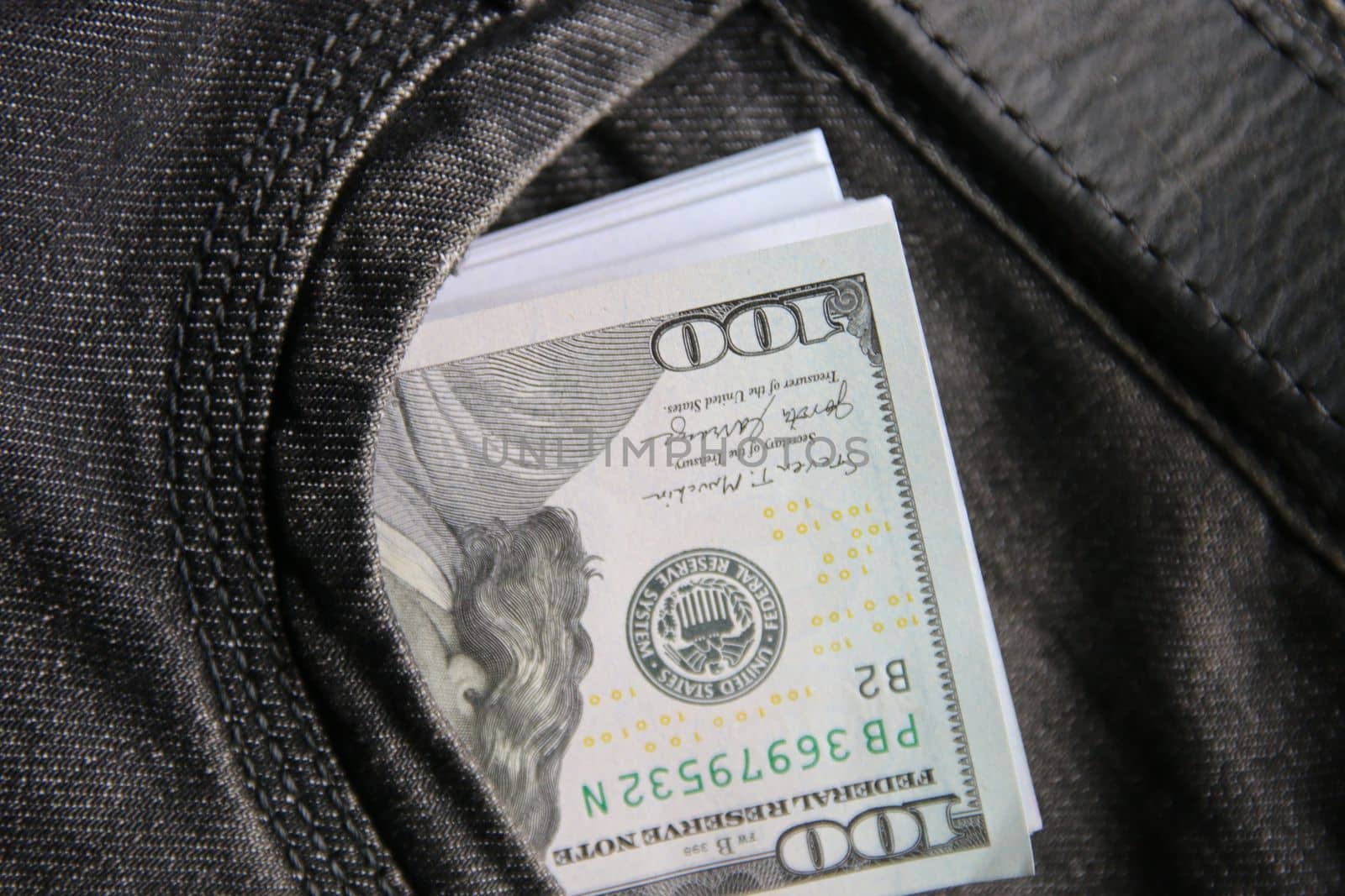 Dollars in a jeans pocket, closeup.