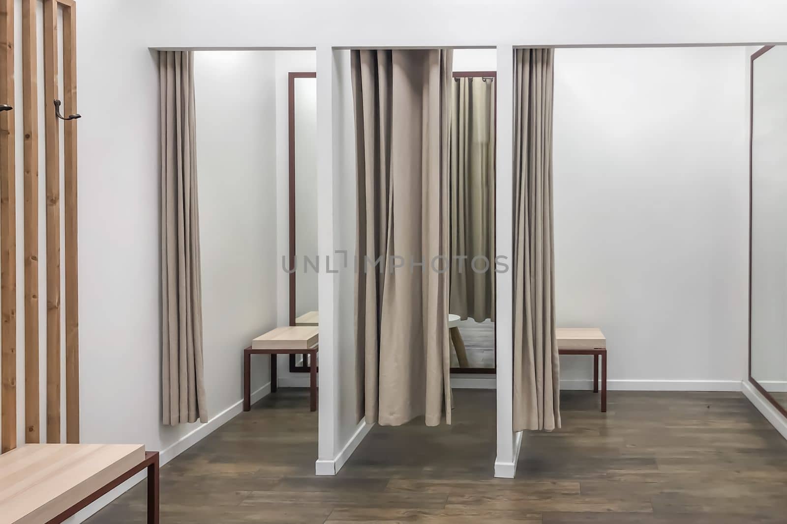 A row of dressing booths for trying on clothes in a store