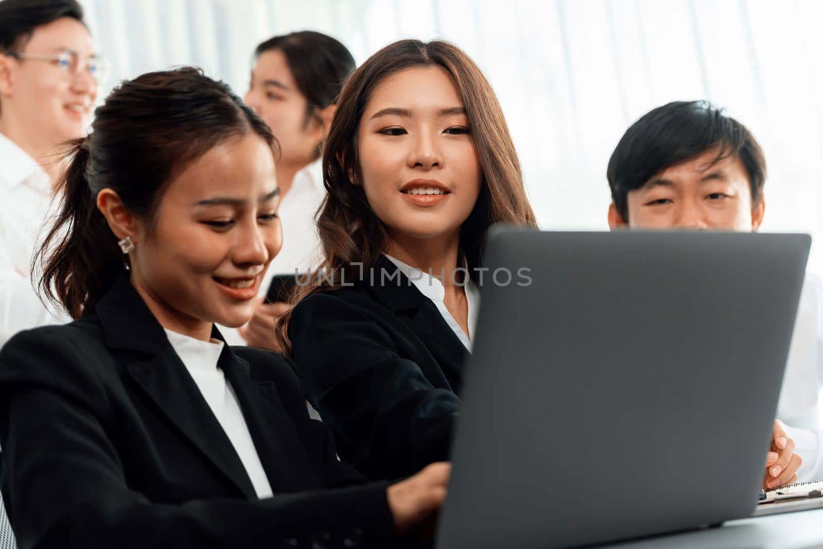 Harmony in office concept as business people analyzing dashboard paper together in workplace. Young colleagues give ideas at manager desk for discussion or strategy planning about project.