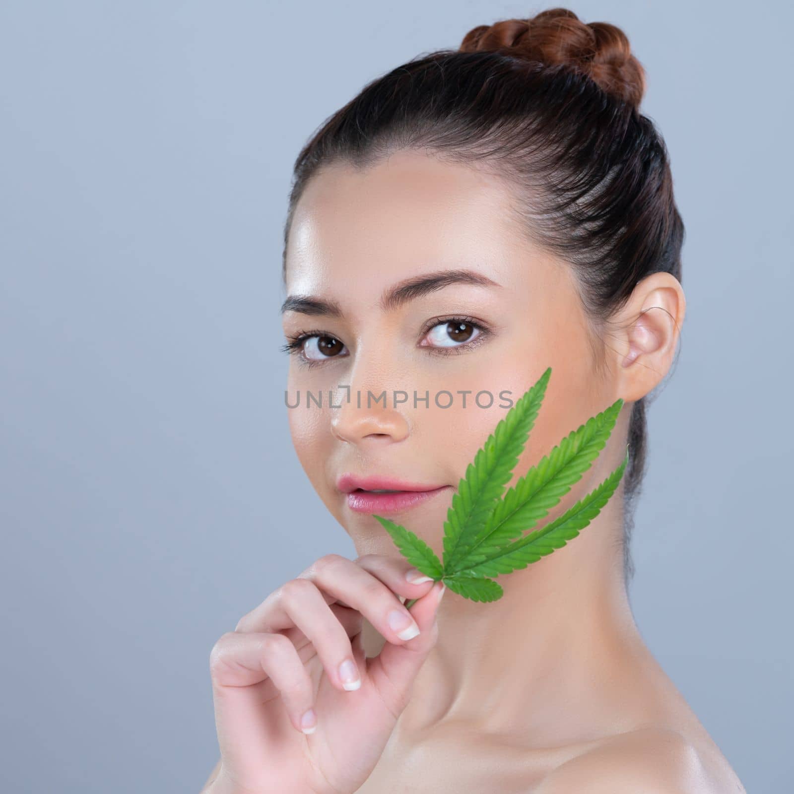 Closeup glamorous woman hold green leaf as cannabis beauty concept. by biancoblue