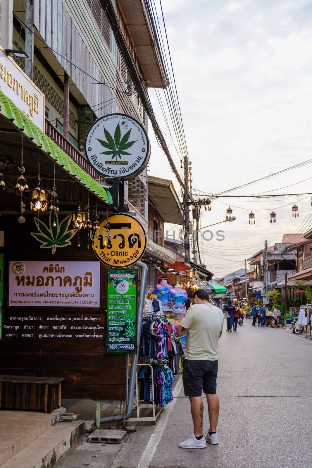 Chiang Khan village North Eastern Thailand February 2023, tourist outside a cannabis Marijuana shop in the village of Chiang Khan