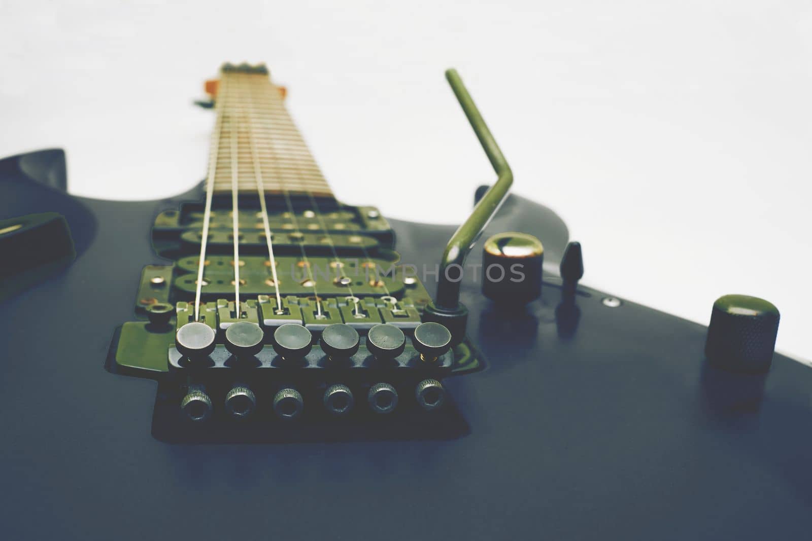 a stringed musical instrument, with a fretted fingerboard,incurved sides, and six or twelve strings, played by plucking or strumming with the fingers or a plectrum. body electric guitar with tremolo