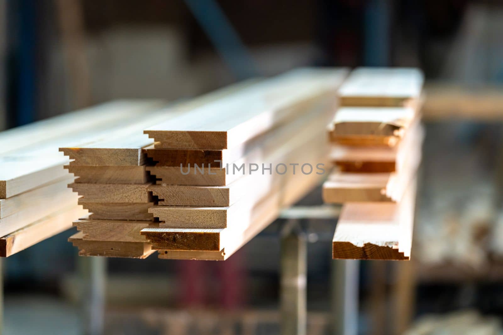 wooden boards on a rack in a carpentry shop. High quality photo