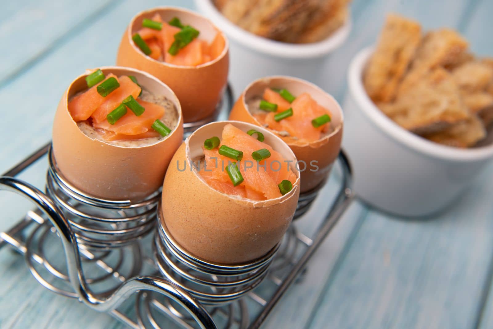 Recipe eggs casserole cooked in the shell with mushroom cream sauce and smoked salmon, High quality photo
