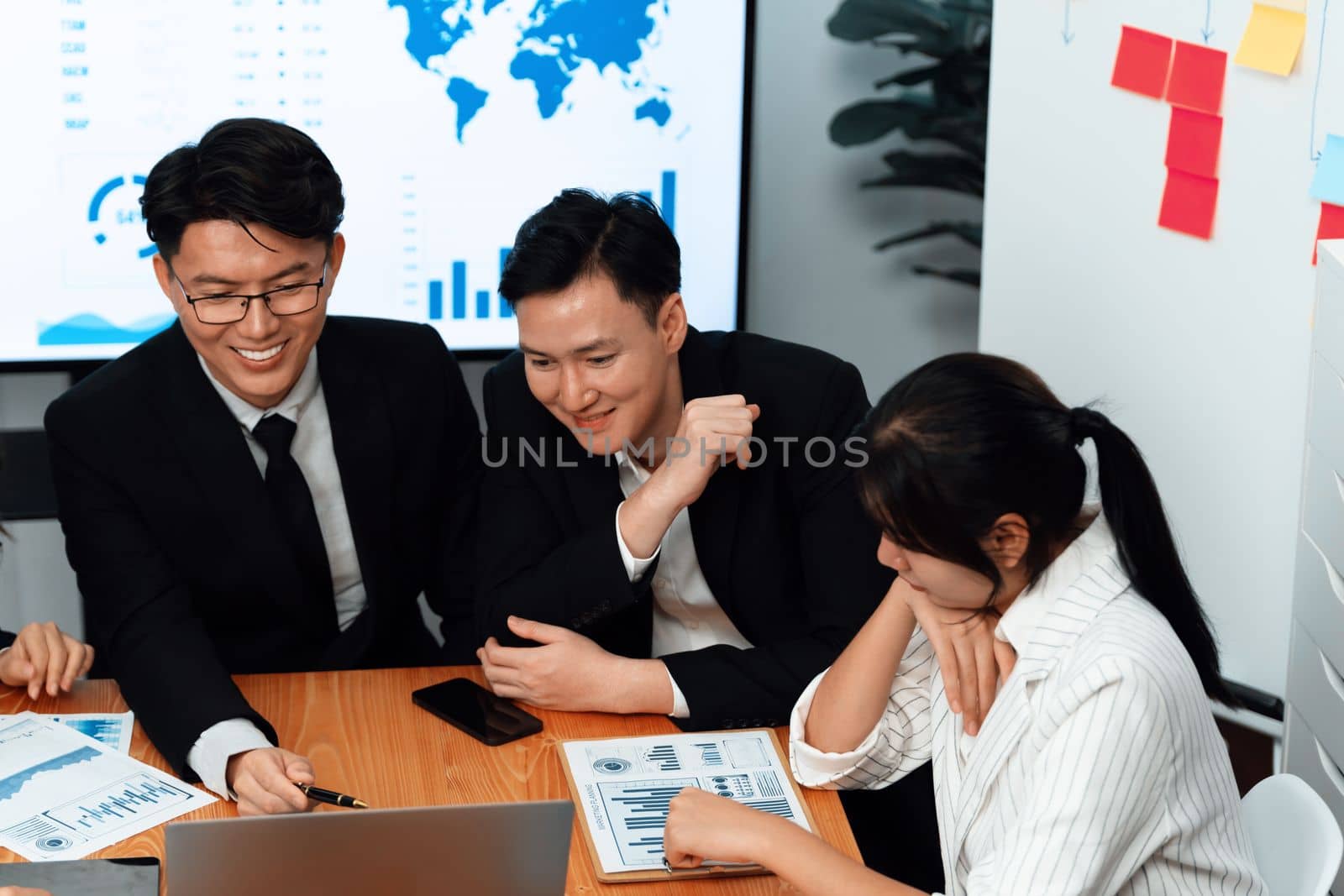 Business team of financial data analysis meeting with business intelligence, report paper and dashboard on laptop for marketing strategy. Business people working together to promote harmony in office.