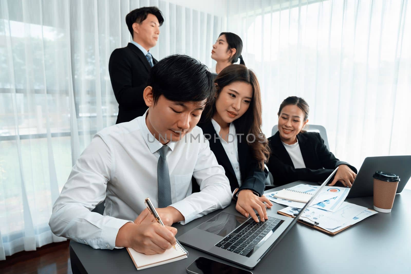 Office worker and manager analyze financial report paper in harmony workplace. by biancoblue