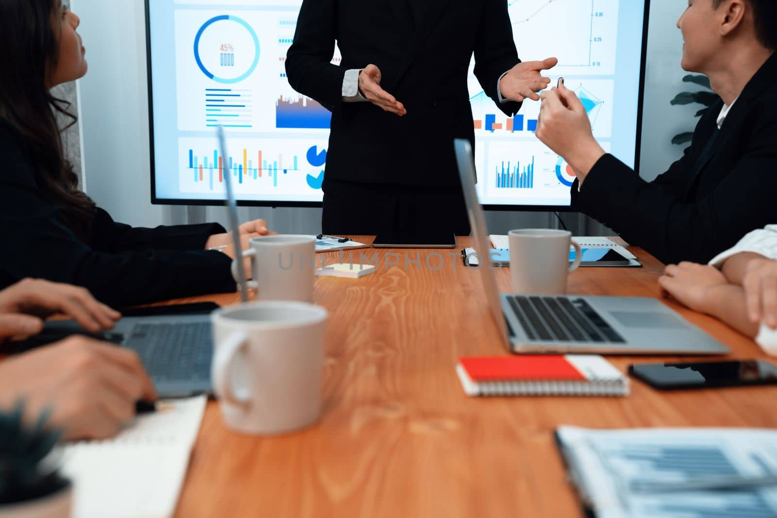 Confidence and asian businessman give presentation on financial analyzed by business intelligence in dashboard report to other people in board room meeting to promote harmony in workplace.