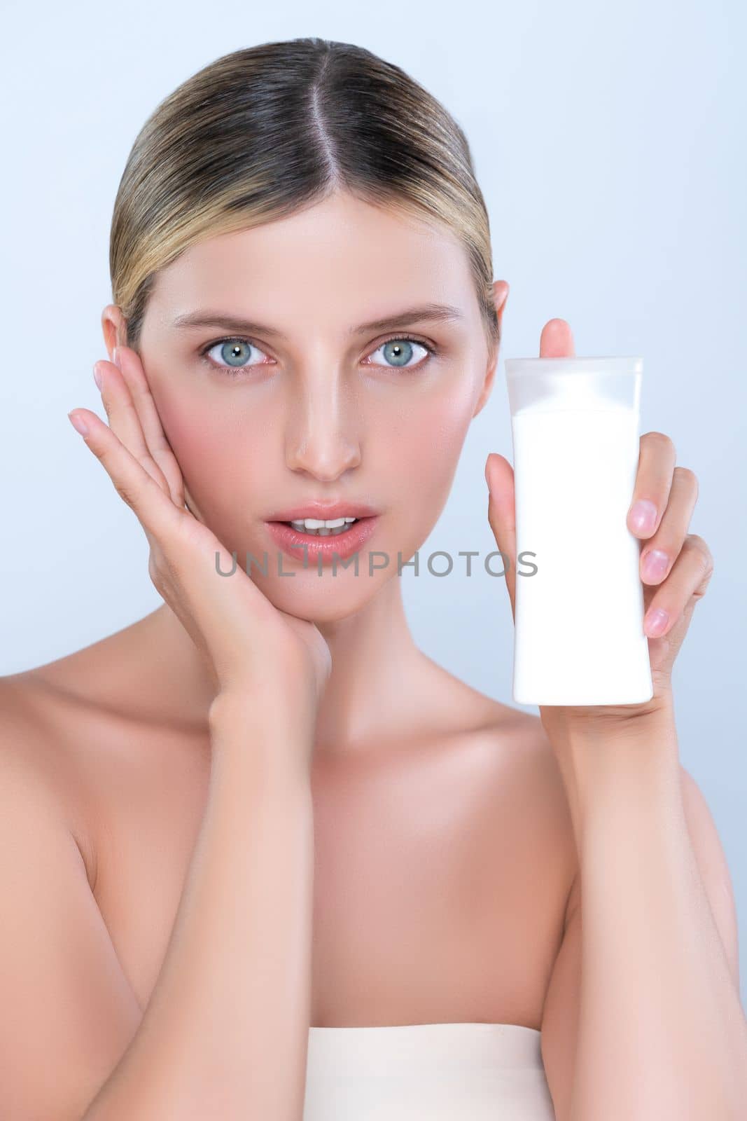 Alluring portrait of perfect skin woman holding mockup moisturizer tube. by biancoblue