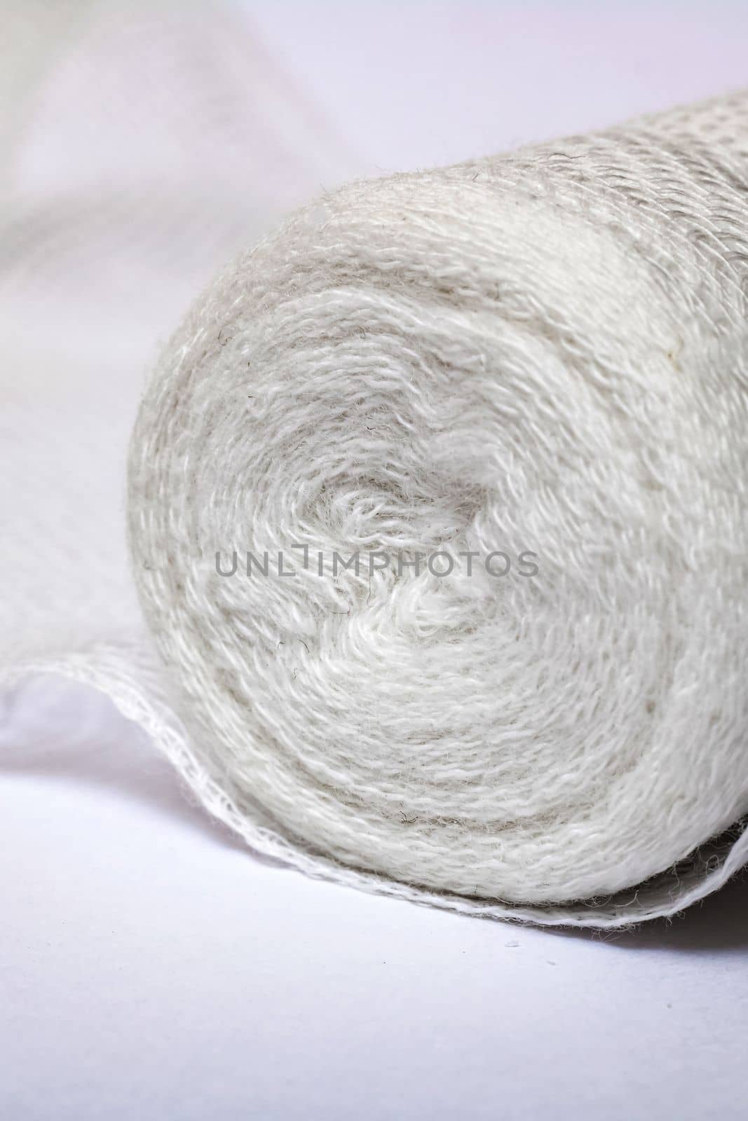 Roll of medical bandage on a white background close up