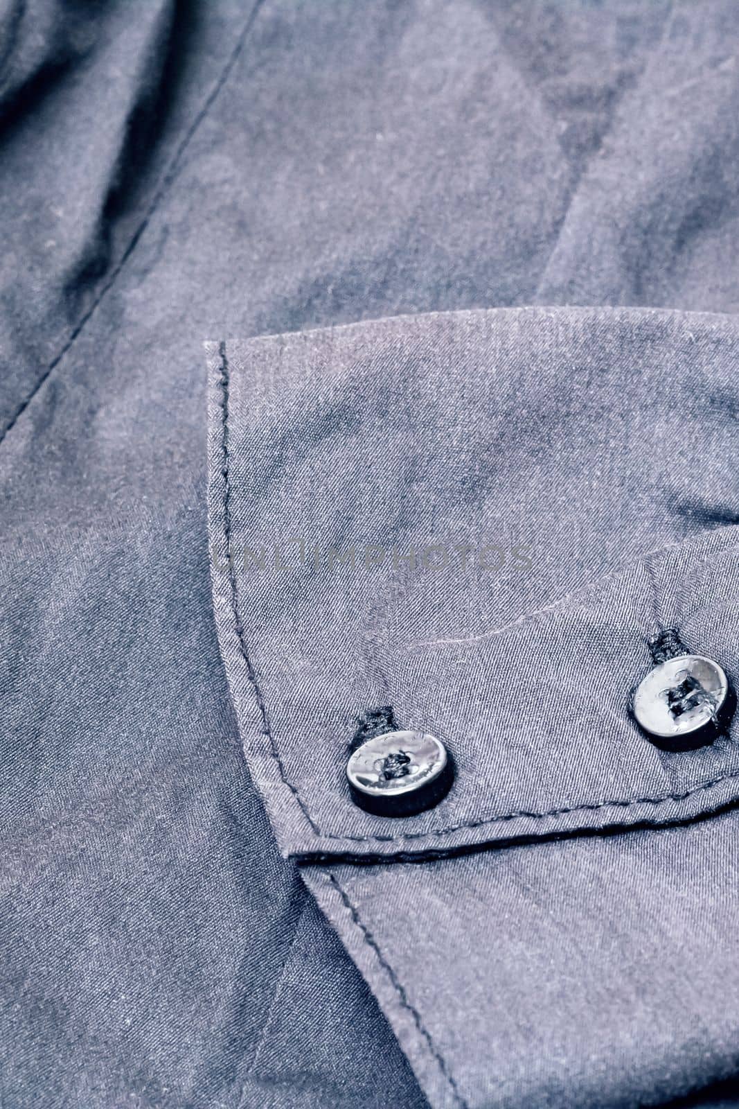 Buttons on a black shirt close up, macro photo