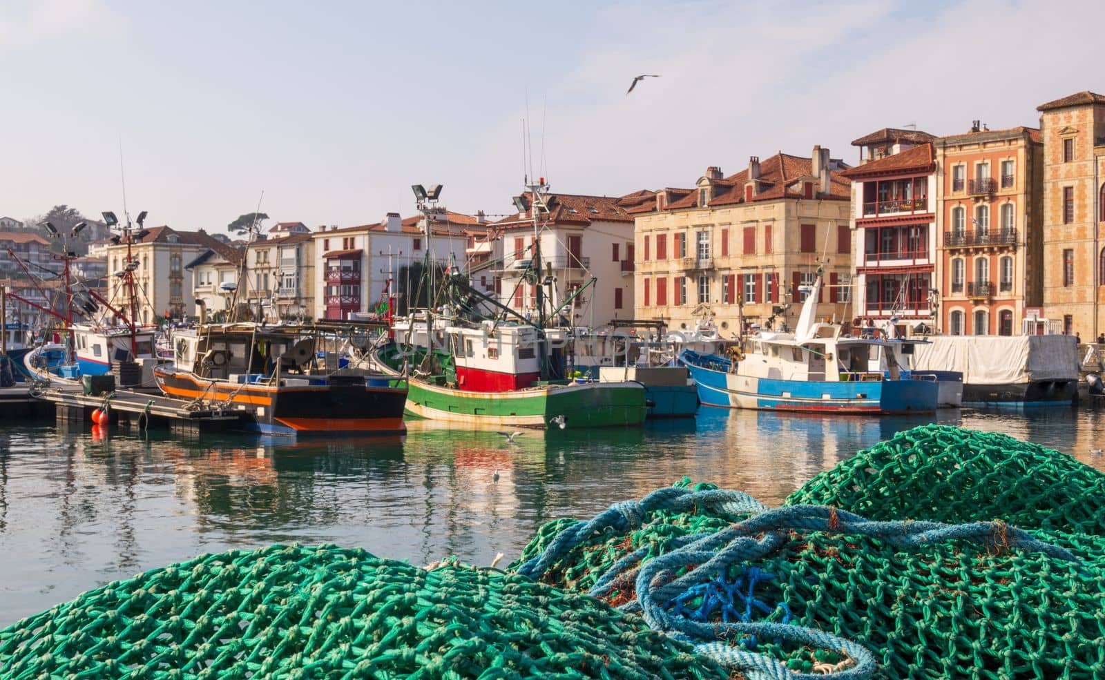 Saint-Jean-de-Luz,  France - February 19, 2023: Fishing port with moored fishing boats a calm sunny day in Saint-Jean-de-Luz, France