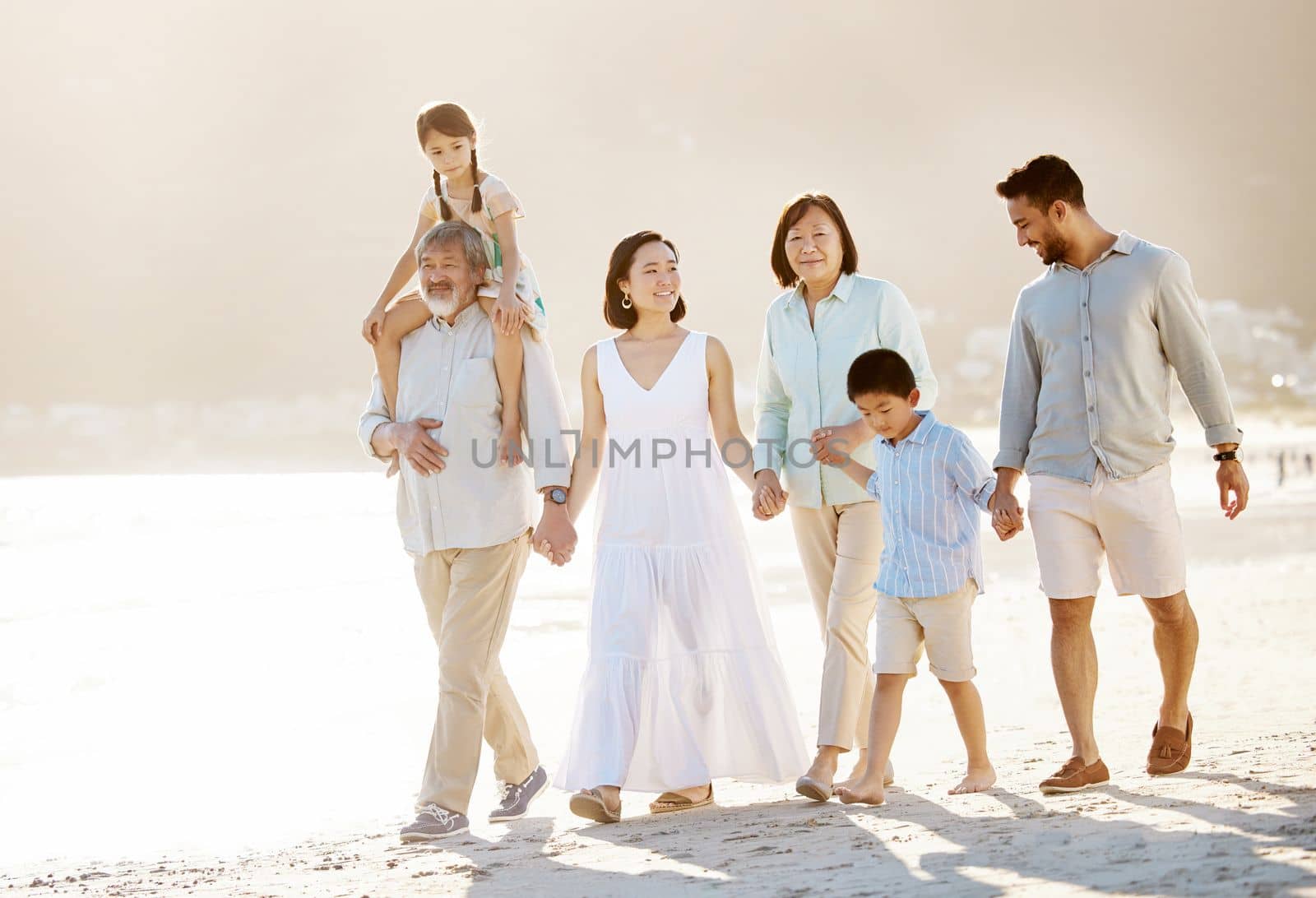 Family beach day. Full length shot of a happy diverse multi-generational family at the beach