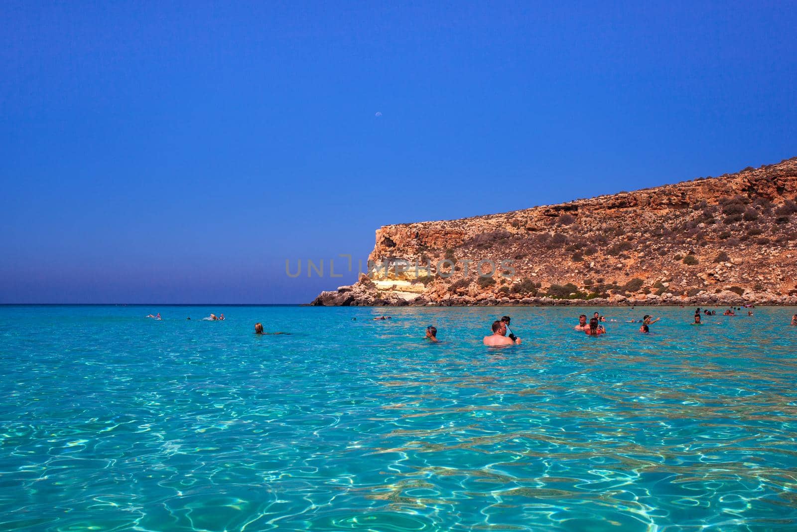 LAMPEDUSA, ITALY - AUGUST, 03: View of the most famous sea place of Lampedusa, It is named Spiaggia dei conigli, in English language Rabbits Beach or Conigli island on August 03, 2018