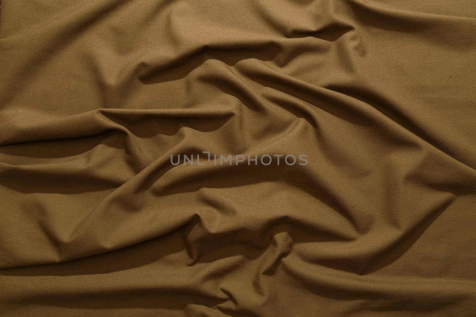 crumpled khaki tan crumpled tan khaki canvas fabric - full frame background and texture.