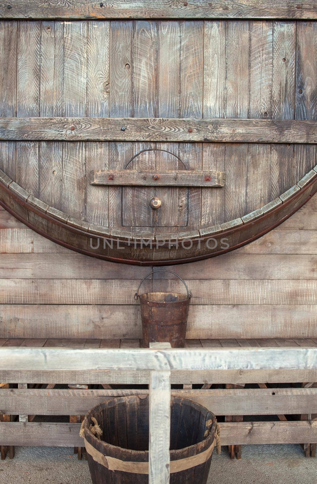 View of big wine barrel and wooden bucket