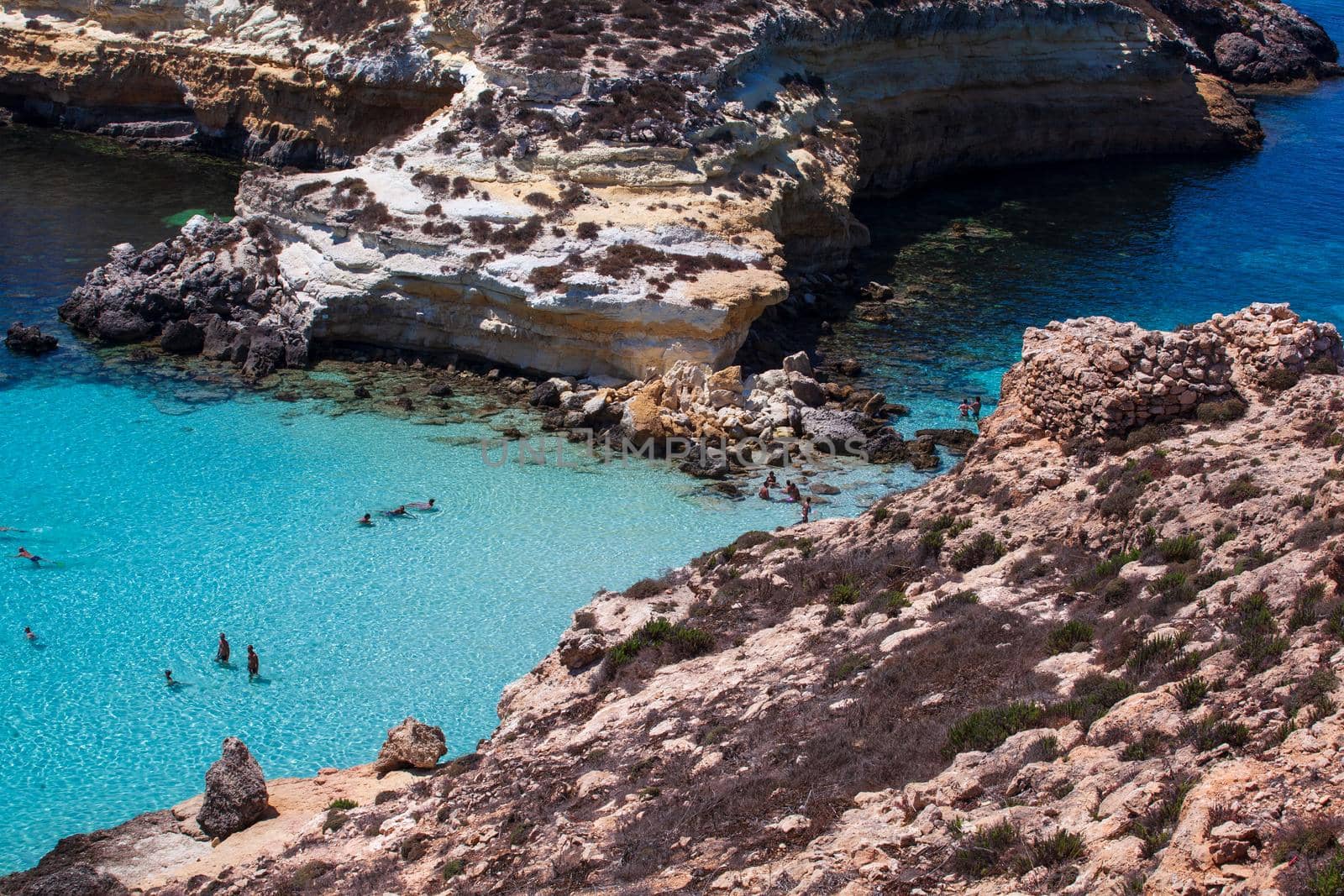 LAMPEDUSA, ITALY - AUGUST, 03: View of the most famous sea place of Lampedusa, It is named Spiaggia dei conigli, in English language Rabbits Beach or Conigli island on August 03, 2018