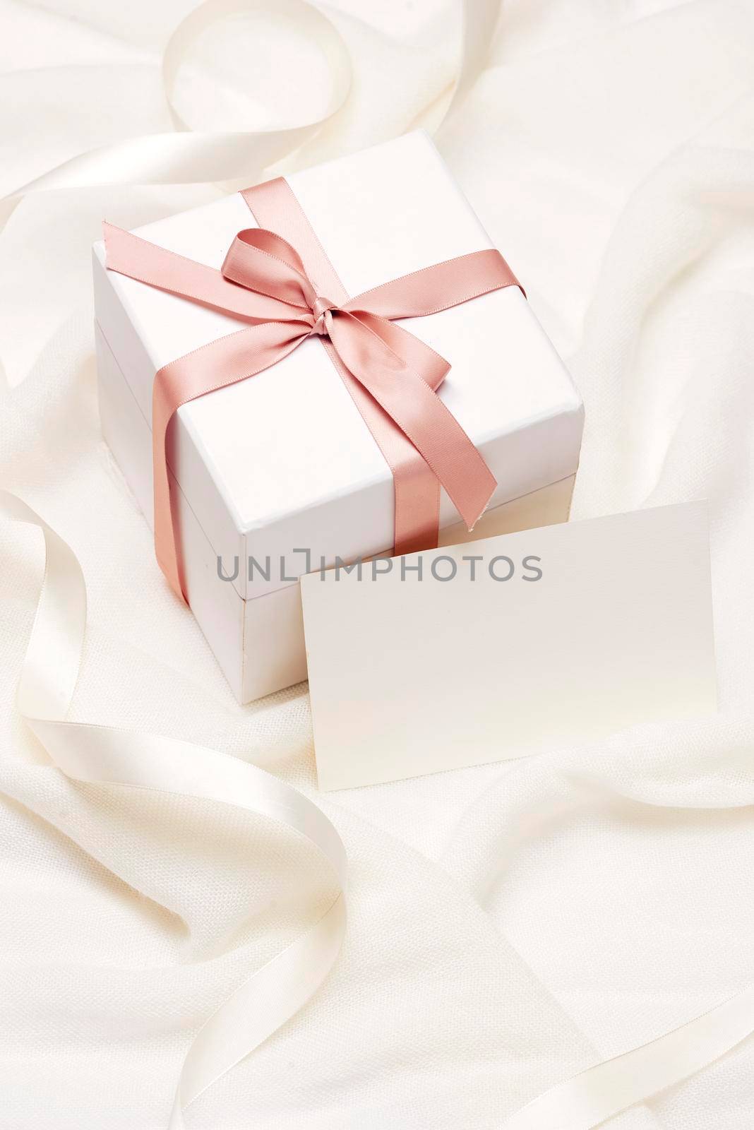 Romantic gift. Present on white silk background. by makidotvn