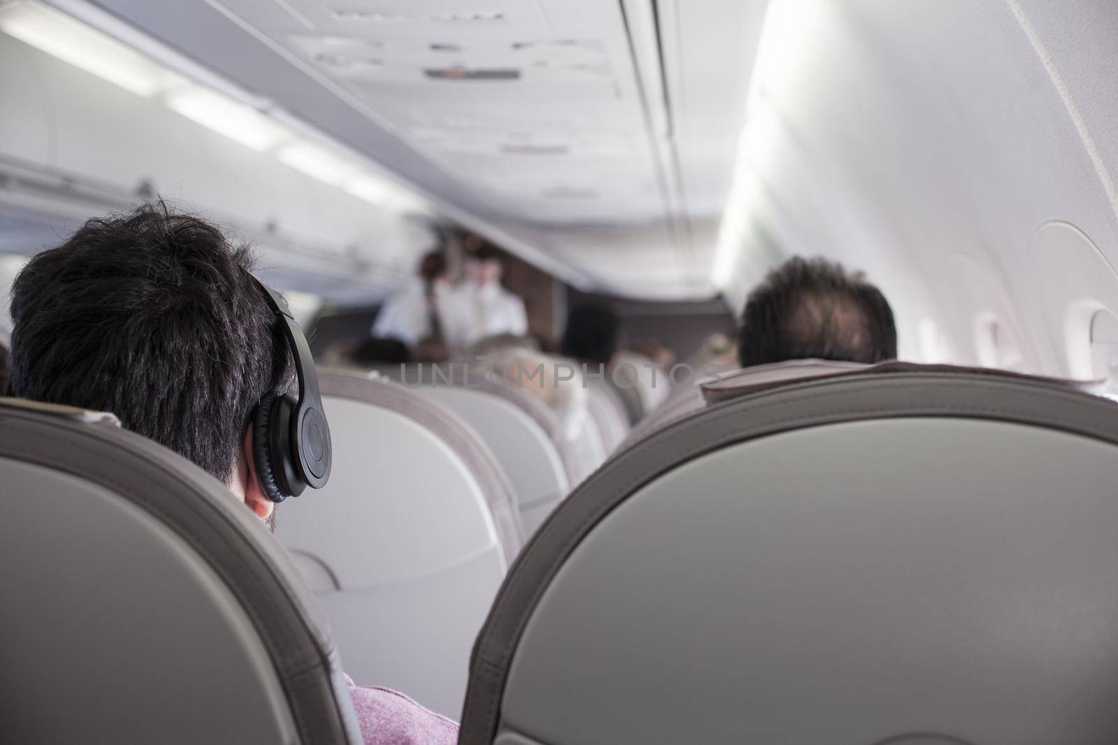 Interior of airplane with passengers on seats