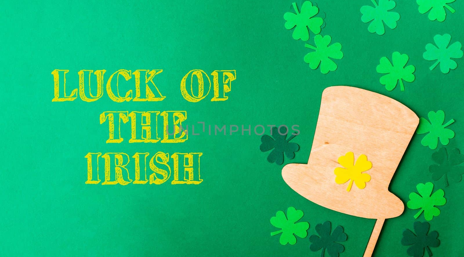 St. Patrick's Day greeting card with clover and leprechaun hat on green background