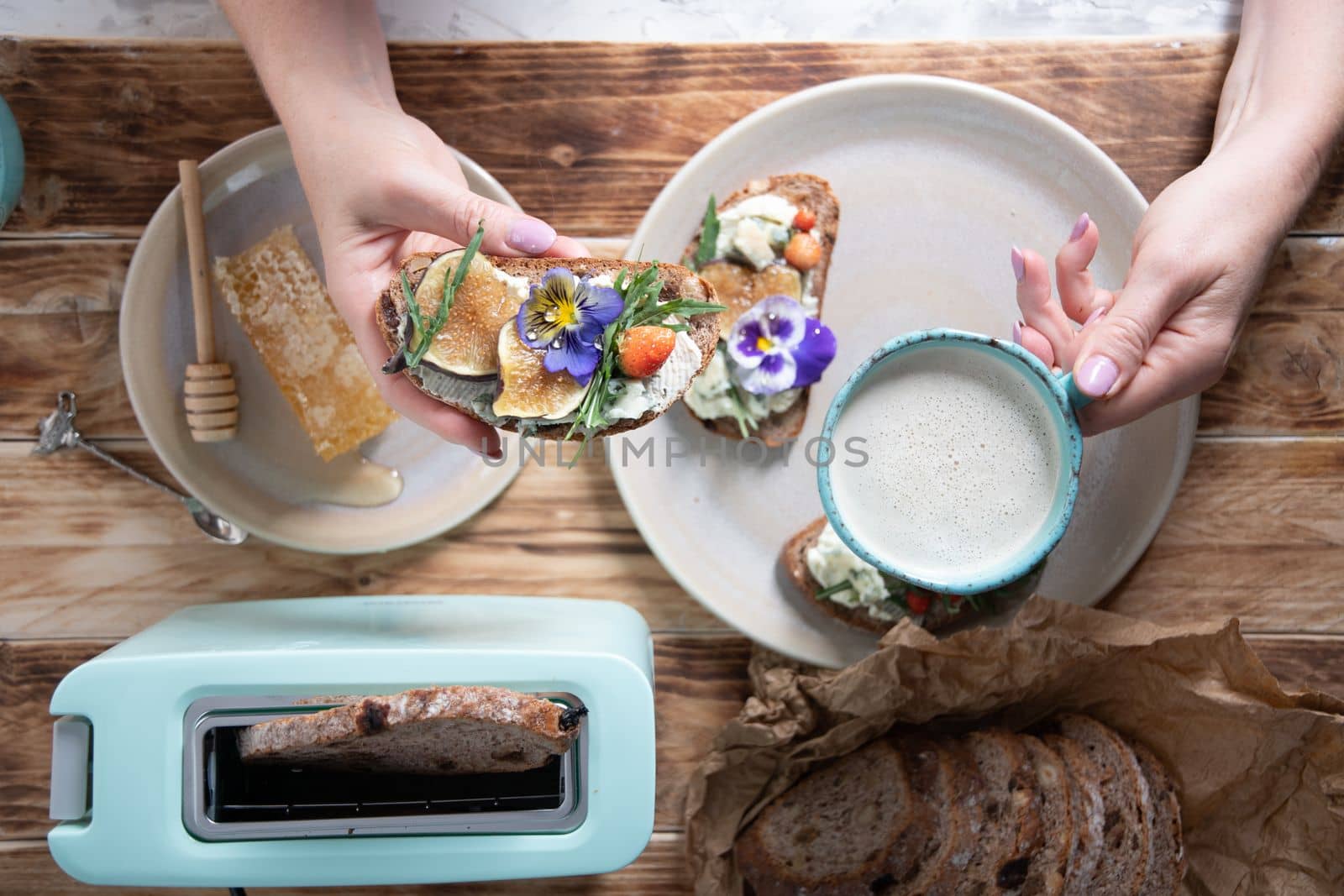 delicious bruschetta with homemade bread, garnished with fig,soft cheese,pansies, top view. High quality photo
