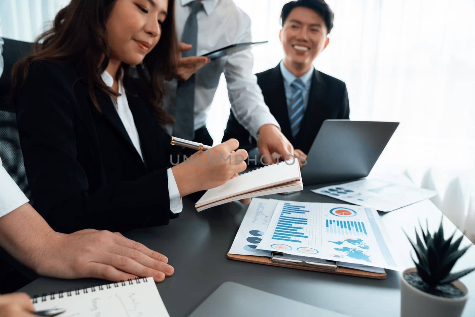 Closeup business team of financial data analysis meeting with business intelligence, report paper and dashboard on laptop for marketing. Business people working together in harmony office.